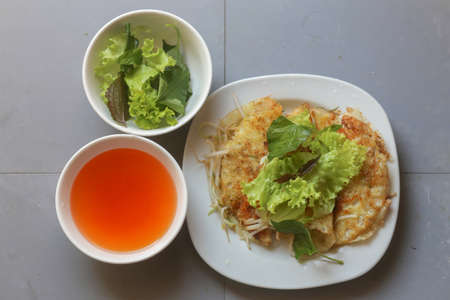 Close-up of crispy Vietnamese pancake with vegetable and fish sauceの写真素材