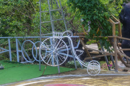 Bicycle model made of steel with large front wheel and small rear wheel for garden decorationの写真素材