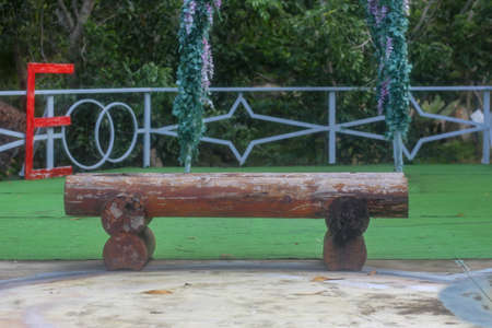 Closeup of a simple wooden chair in the gardenの写真素材