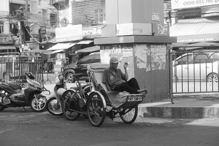 Nha Trang City, Vietnam - 01 May 2023: Portrait of old men smoking on cyclo at Dam market, Nha Trang Cityのeditorial素材