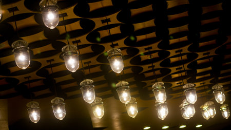 The ceiling is decorated with yellow circle light bulbs in a modern style in Shopping mallの写真素材