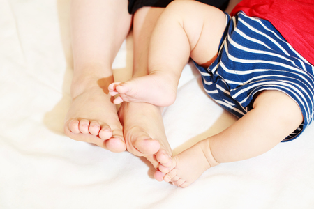 Legs of baby feet and motherの写真素材