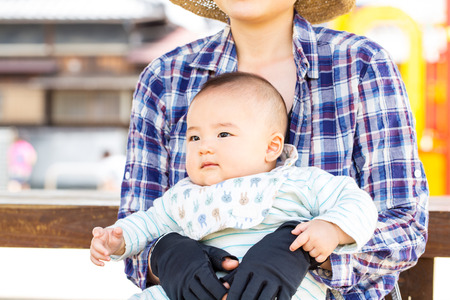 happy mother playing with her son in the parkの写真素材