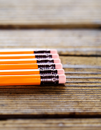 yellow pencils with the eraser lying on wood tableの写真素材