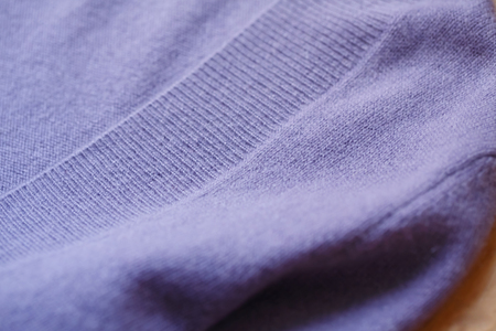 Beautiful, luxurious, knitted sweater in purple on the floor, autumn, winter, warm.の写真素材