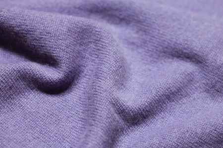 Background texture of purple pattern knitted fabric made of cotton or wool closeupの写真素材