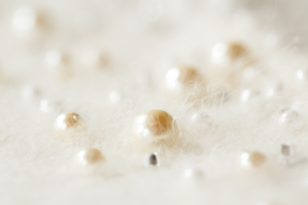Neck of the Angolan white sweater, pearl and beads. Close upの写真素材