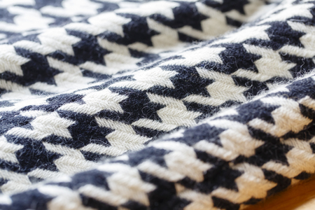 Background texture of hound's-tooth check pattern fabric made of cotton or wool closeupの写真素材