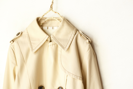 A beige elegant trench coat isolated over white. Close upの写真素材