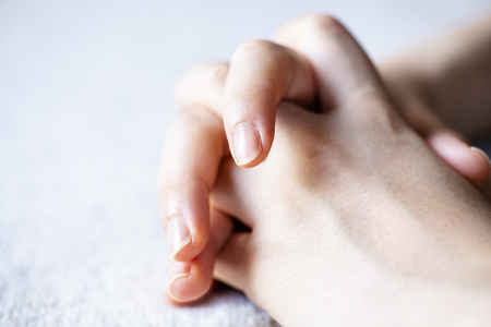 Photo of hands of tha woman on the carpet. close up.の写真素材