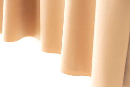 A curtain or clothes of the orange beige and sunshine.Close upの写真素材