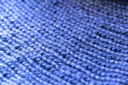 Background texture of blue pattern knitted fabric made of cotton or wool. close up.