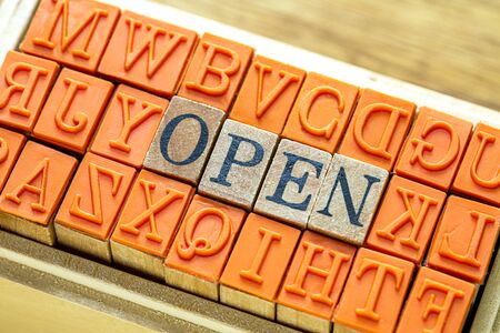 OPEN - isolated abstract in wood type stamps against wooden background and copy space.close up.の写真素材