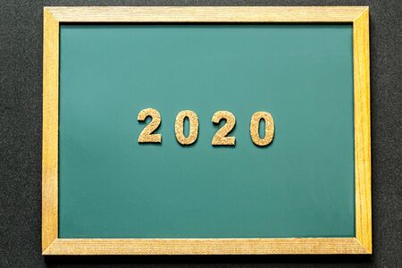 Set of 2020 of cork isolated on green blackboard and black color background and opy space. Flat lay.の写真素材