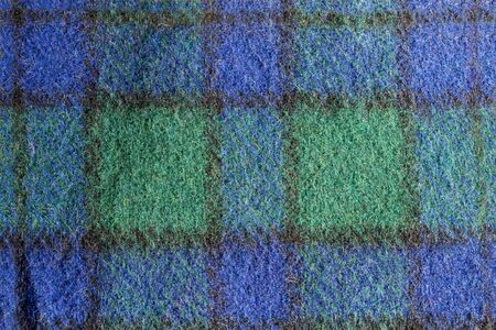 Stack of woolen checked cloth, autumn and winter concept.close up.black, green,navy blue.