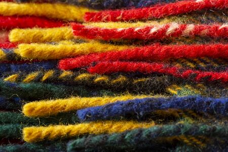 Close up of the colorful woolen yarn.red, yellow, green, dark blue.の写真素材