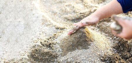 child's hands and sandbox play with sand and copy space. Sand art and play.の写真素材