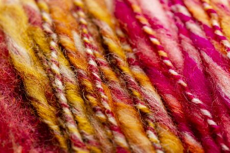 close up of colorful knitting yarn wool yarn skein-red, white,orange,brown,yellow.の写真素材