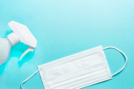 Set of medical mask and Antiseptic solution on blue background and copy space.の写真素材