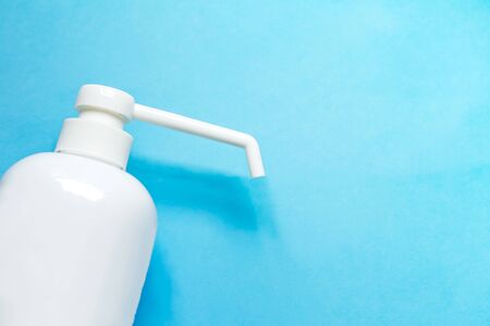 bottle with antiseptic solution isolated on a blue background and copy space.の写真素材