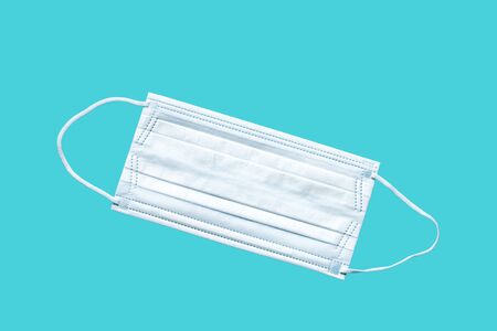Medical mask, Medical protective mask on blue background. Disposable surgical face mask cover the mouth and nose. Healthcare and medical concept.の写真素材