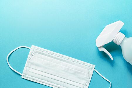 Set of medical mask and Antiseptic solution on blue background and copy space.の写真素材