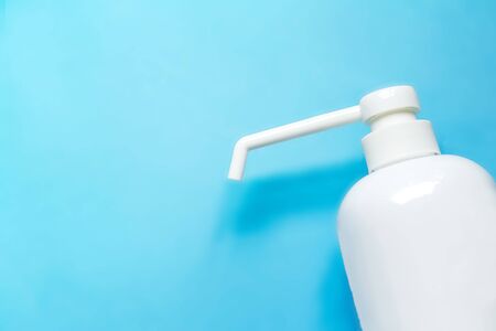 bottle with antiseptic solution isolated on a blue background and copy space.の写真素材