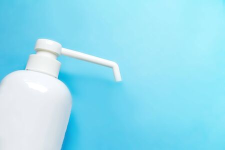 bottle with antiseptic solution isolated on a blue background and copy space.の写真素材