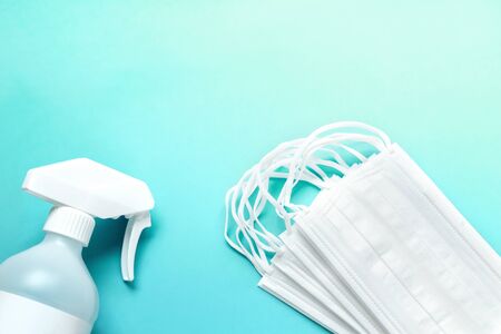 Set of medical masks and Antiseptic solution on blue background and copy space.の写真素材