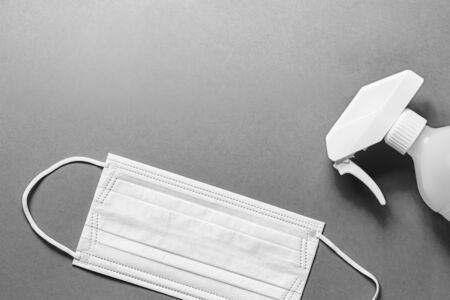 Set of medical mask and Antiseptic solution on black and white background and copy space.の写真素材