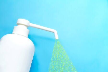 bottle with antiseptic solution isolated on a blue background and copy space.の写真素材