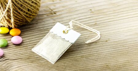 a pretty tag and marble chocolate and hemp line and copy space and wood background.の写真素材
