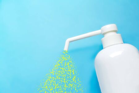 bottle with antiseptic solution isolated on a blue background and copy space.の写真素材