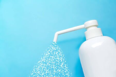 bottle with antiseptic solution isolated on a blue background and copy space.の写真素材