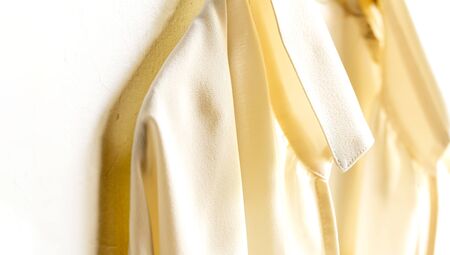 a blouse or shirt in white hanging on clothes hanger on white background.Close up and copy space.の写真素材