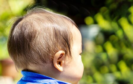 A close up shot of the back of a black-haired baby's head and close up and copy space.の写真素材