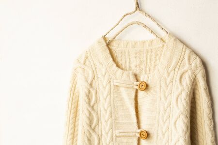 Beautiful, luxurious, a whole knitted cardigan in light beige on white background.の写真素材