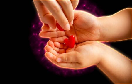 adult and little child holding red hearts, close up isolated and energy on black background. health care, love and family concept, world heart day.の写真素材