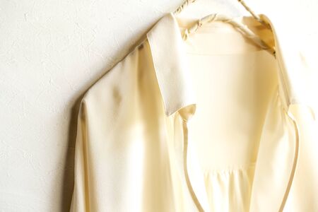 a blouse or shirt in white hanging on clothes hanger on white background.Close up and copy space.の写真素材