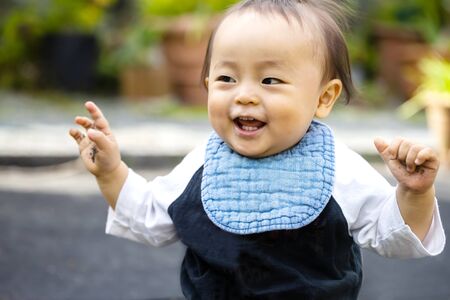 baby plays in the outside and copy space .baby is in high spirits with smile.の写真素材
