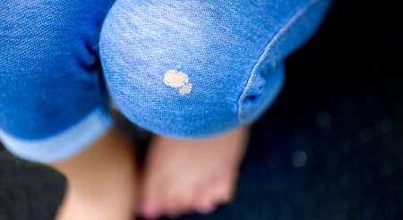blue jeans with holes sitting on the black background and copy space.の写真素材