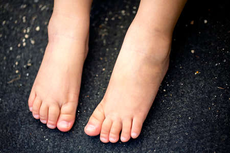 close up to the child's feet isolated on black background and copy space.の写真素材