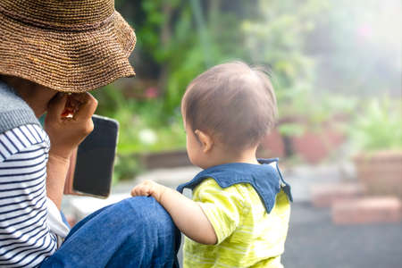 Happy grandmother and son, record video call on smartphone, take pictures on phone, joys of fun and relaxation application is an online social video chat call and copy space.の写真素材