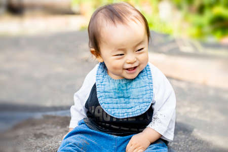 Portrait of happy joyful beautiful little boy isolated plays in a sandbox of the outside and copy space.の写真素材