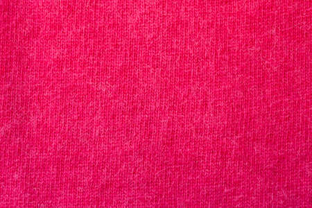Background texture of red pattern knitted fabric made of angora or wool. close up.の写真素材