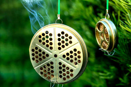 container for mosquito-repelling incense on green background and copy space.の写真素材