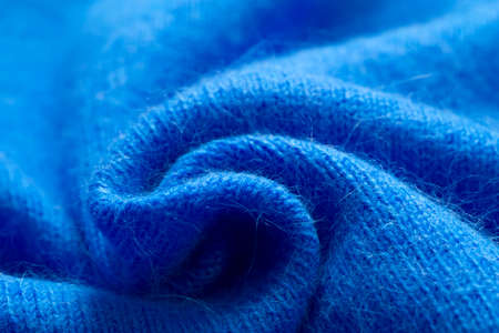 Background texture of blue pattern knitted fabric made of cotton or wool or angora close up.の写真素材