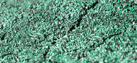 Dried cracked or rich earth soil ground texture background. crack pattern of sunny rich earth soil and copy space and green.の写真素材