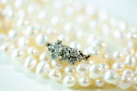 the clasp of pearl necklace on a white background and copy space. close up.の写真素材
