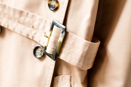 Beige trench coat with belt isolated and close up.の写真素材